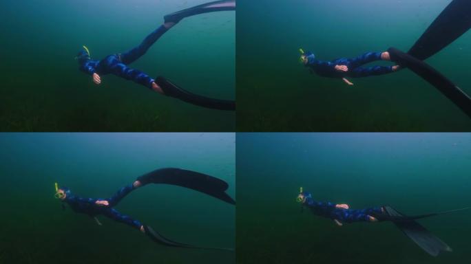 湖自由潜水。女人在图尔戈亚克的淡水湖水下游泳，享受海底世界