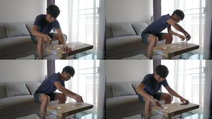 亚洲男子打开一个装有未完成桌子的盒子