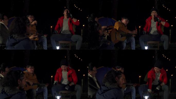 4k亚洲男人朋友在露营时一起喝啤酒和唱歌