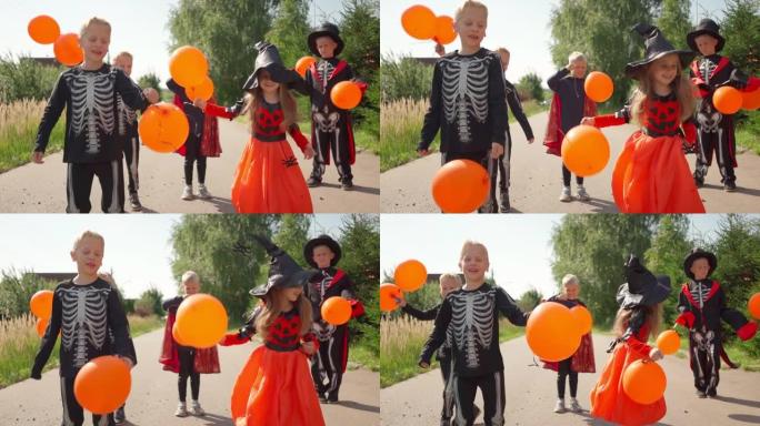 万圣节孩子们用橙色气球跳跃和乐趣。去收集糖果。把戏-或者