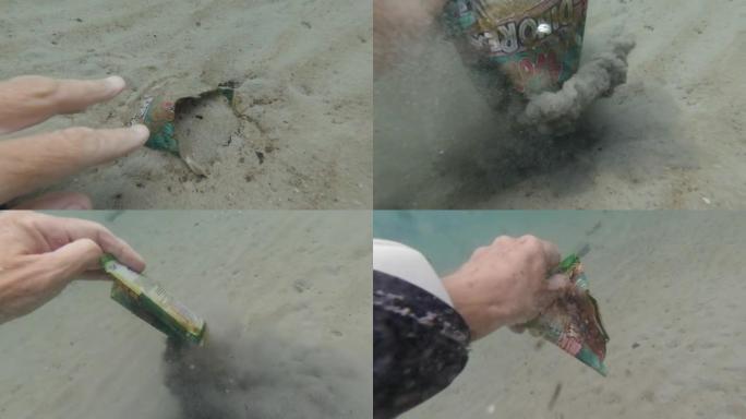 女潜水员POV手从海床上清除垃圾