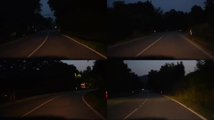 晚上在城市外开车，乡村道路，视点POV，黑暗，路灯。