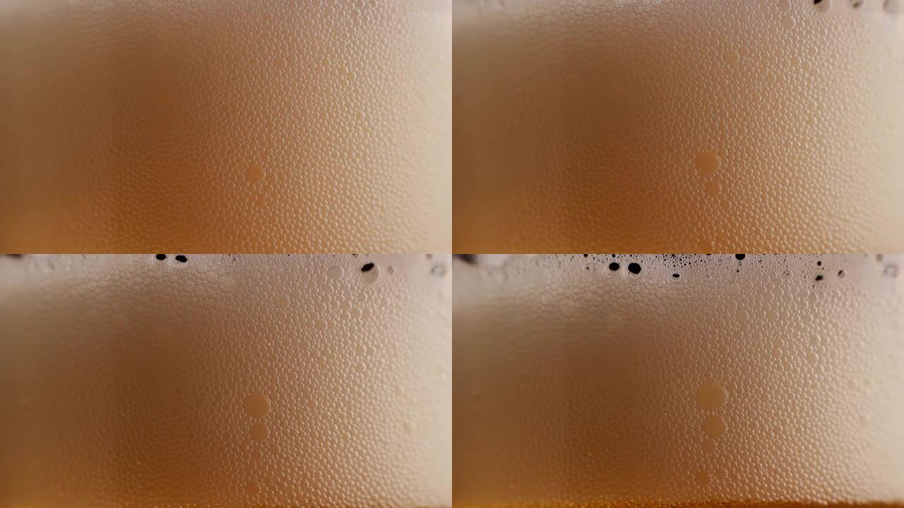 通过透明玻璃的极端微距镜头显示生啤酒酒精饮料中的气泡