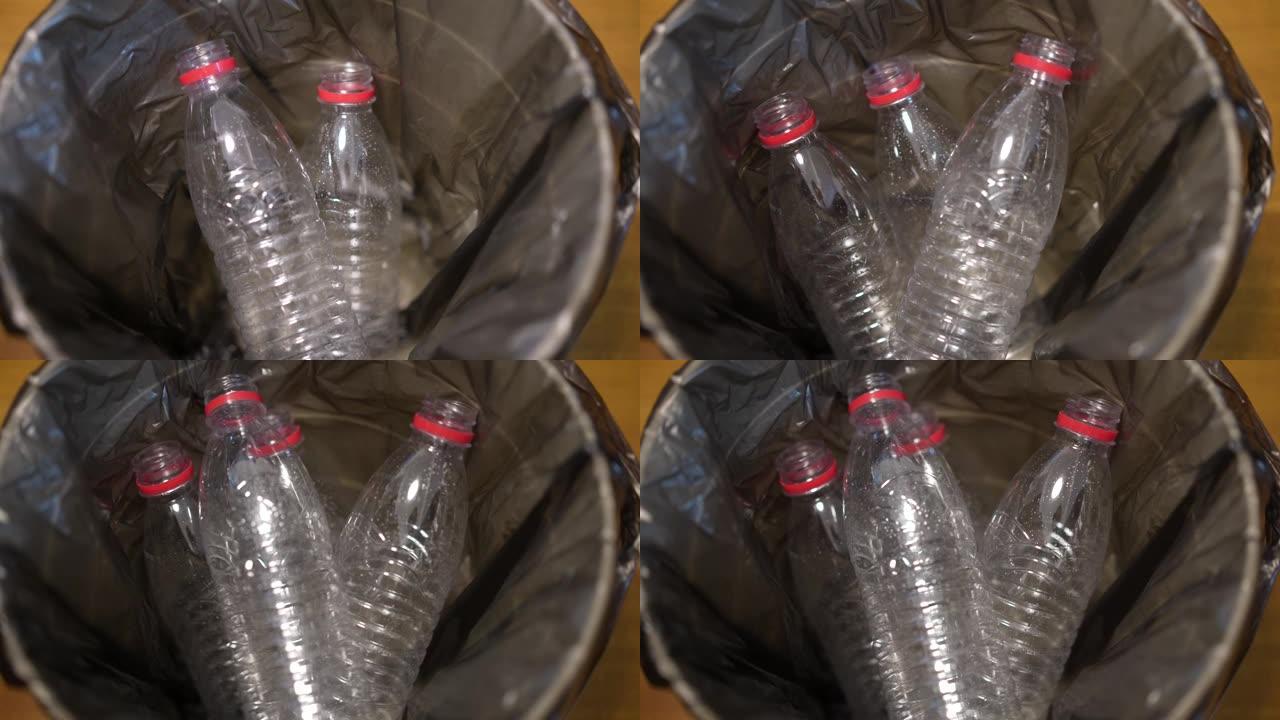 用手将空的塑料饮用水瓶放入垃圾箱