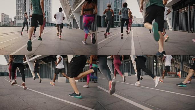穿着轻便鞋子和衣服的进步耐力运动员穿过城市街道。跑步俱乐部，一群志同道合的人，年轻男女