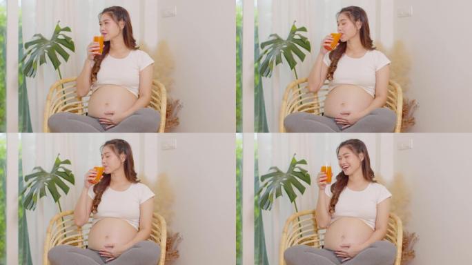 健康孕妇亚洲妇女喝胡萝卜汁维生素a和高维生素c和K，怀孕健康与天然胡萝卜新鲜果汁概念