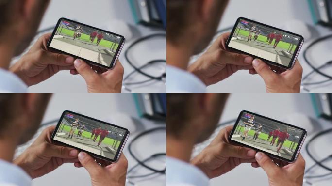 男性医生在智能手机上观看橄榄球比赛的合成