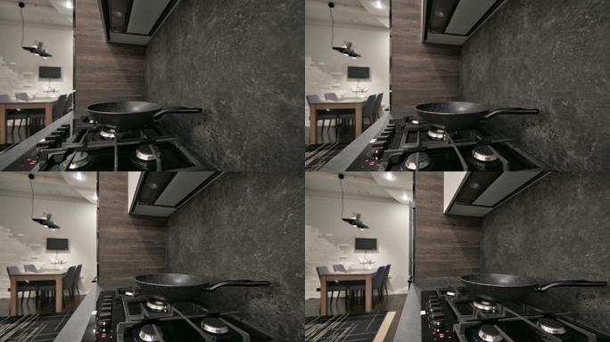 现代深棕色、灰色和黑色厨房的燃气灶顶部