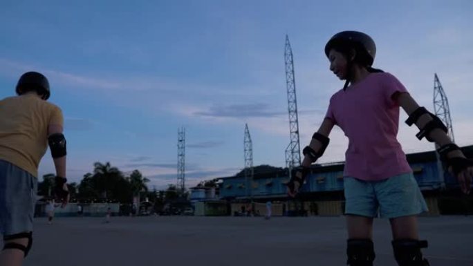 剪影亚洲儿童一起在公共游乐场学习玩防滑鞋，运动生活方式理念。