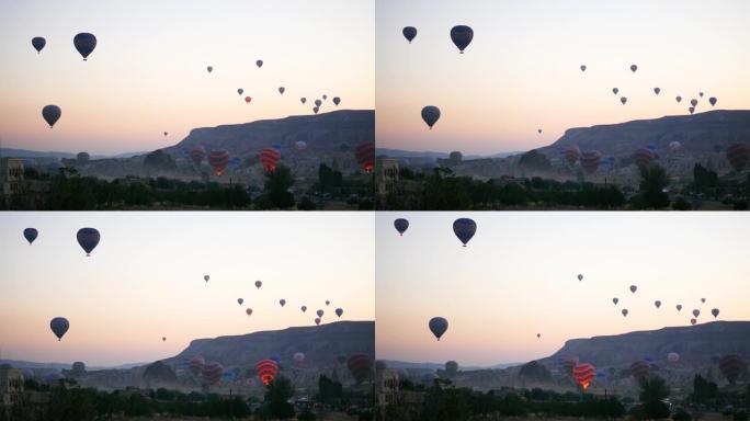 卡帕多西亚有很多气球在天空中飞行。热气球在日出时起飞。