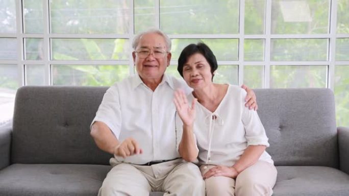 亚洲妻子和丈夫的一对夫妇用视频通话给侄子，笑脸快乐。社交距离。