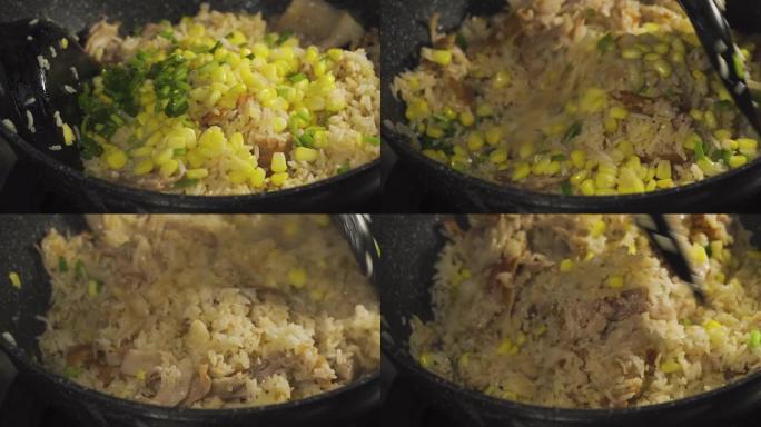 有人把青葱块放在米饭上。准备用培根，玉米和大葱做炒饭。泰国菜著名菜单。