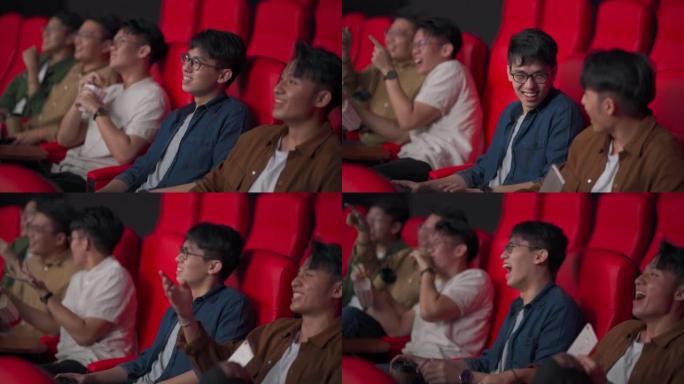 亚洲华裔年轻人观众笑着看电影坐在电影院电影院里欣赏