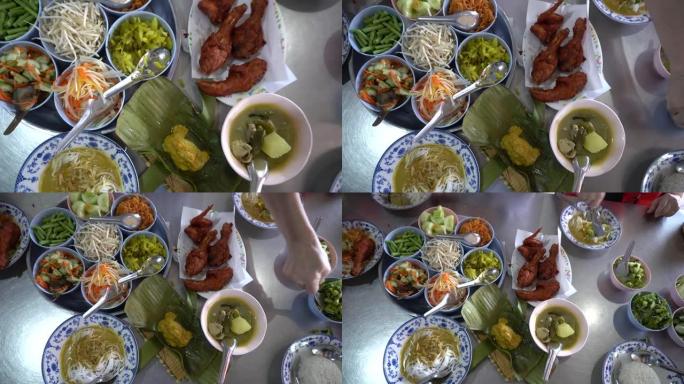 吃卡诺姆·吉恩、米饭粉丝面条配咖喱和蔬菜以及炸鸡泰国普吉岛当地传统餐