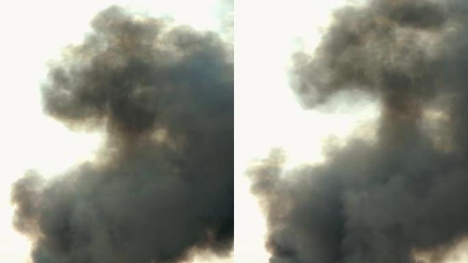 天空中的黑烟。着火、燃烧农业垃圾、工厂管道或爆炸。烟雾旋转并被风带走。