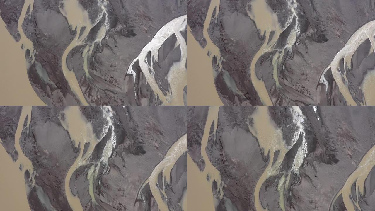 野生冰川河流和冰碛沉积物的空中无人机视图。来自Vatnajokull冰盖沉积物冰ora的蜿蜒融水河流