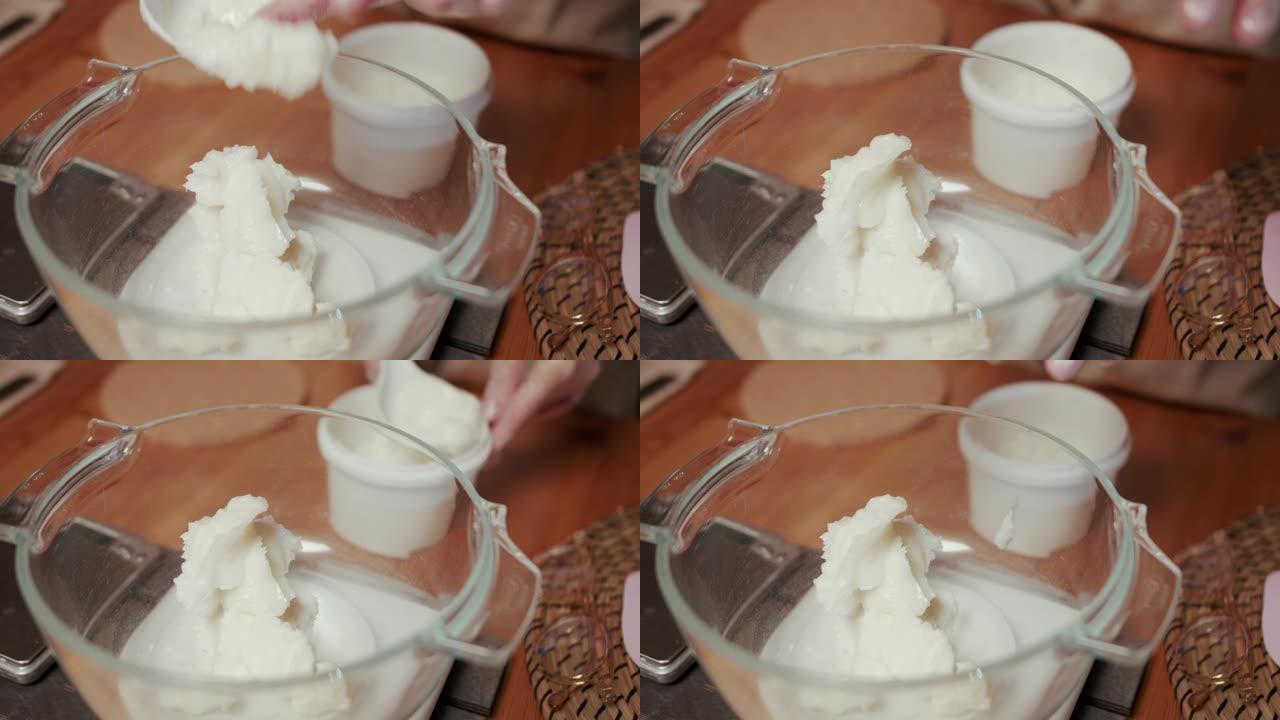 女人的手在肥皂切割机上将肥皂切成条状的特写镜头。她把所有的酒吧排成一排