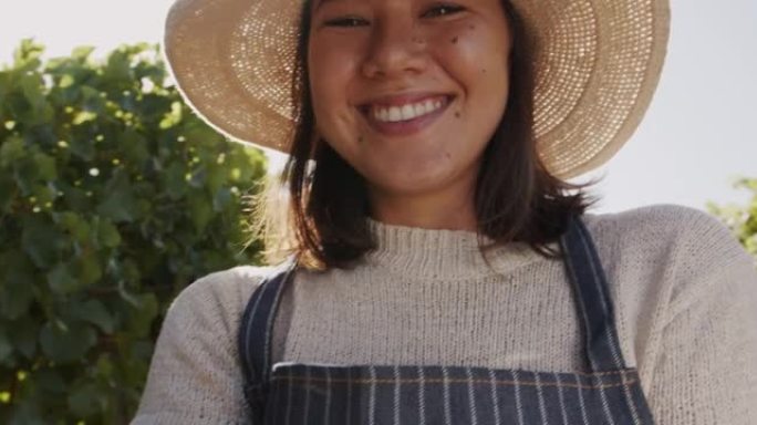 4k视频片段，一名年轻女子站在葡萄园中
