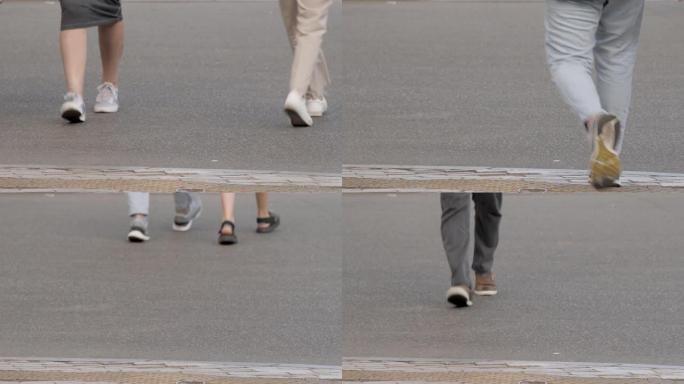 特写脚街头步行鞋。行人人行道街道人抽象城市脚踏人路步行腿过马路。匿名人士走路的脚鞋腿关闭了城市生活