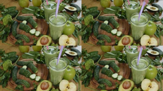 有机鲜榨绿色蔬菜和水果冰沙放入玻璃杯中