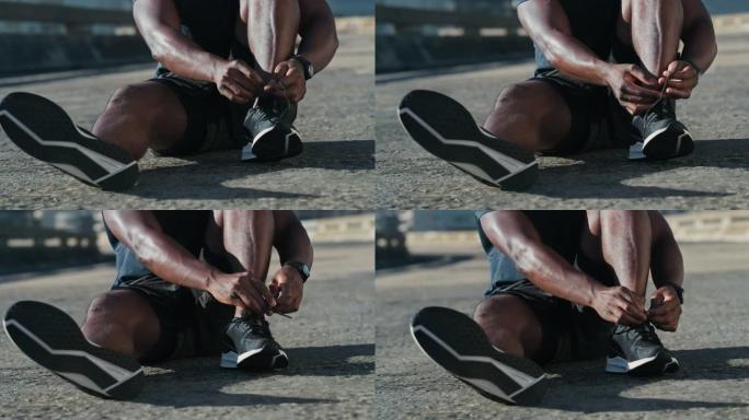 4k视频片段，一个无法识别的男人在城市道路上系鞋带