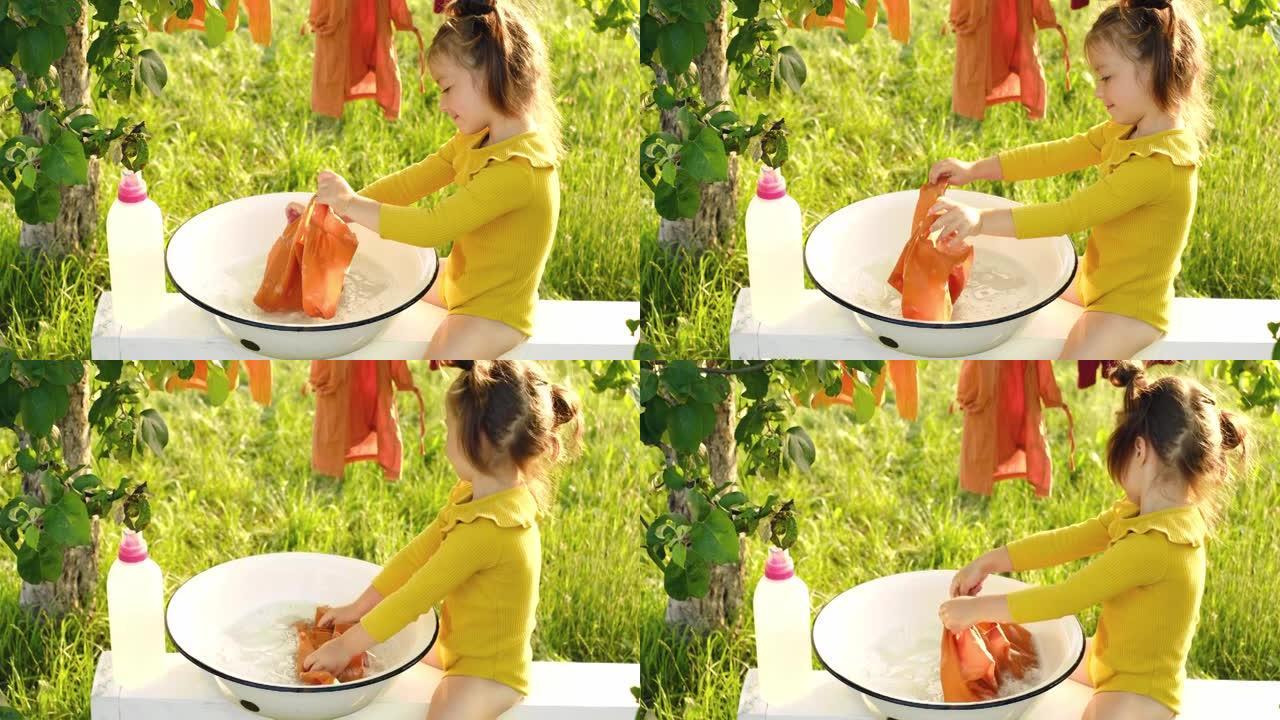 一个女孩用盆里瓶子里的液体洗衣粉洗衣服