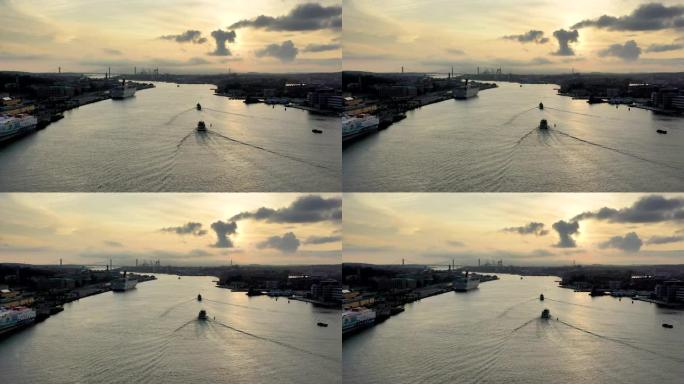 哥德堡空中无人驾驶飞机在日落时在g ö ta ä lv河上航行的船只。