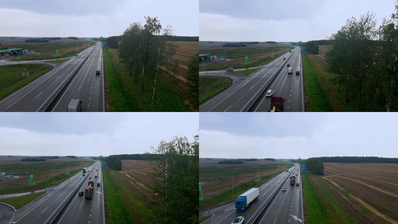 道路和运输的鸟瞰图。人们在高速公路上开车旅行。背景上的白俄罗斯荣耀纪念碑。戏剧性的天空。物流和旅行概