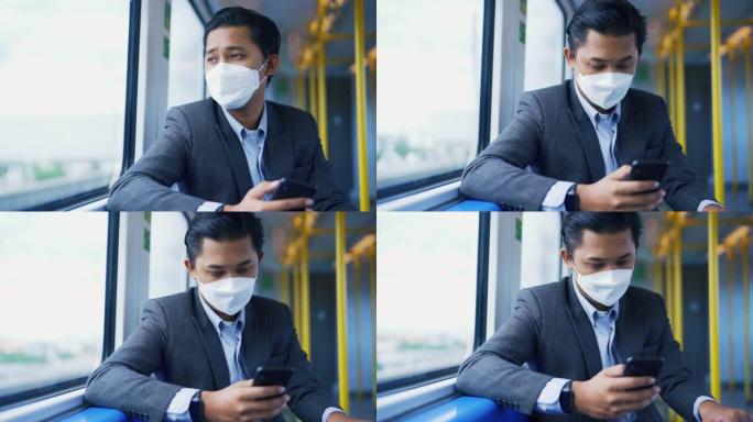 在亚洲冠状病毒爆发期间，男子乘火车旅行时戴着防护口罩使用电话。