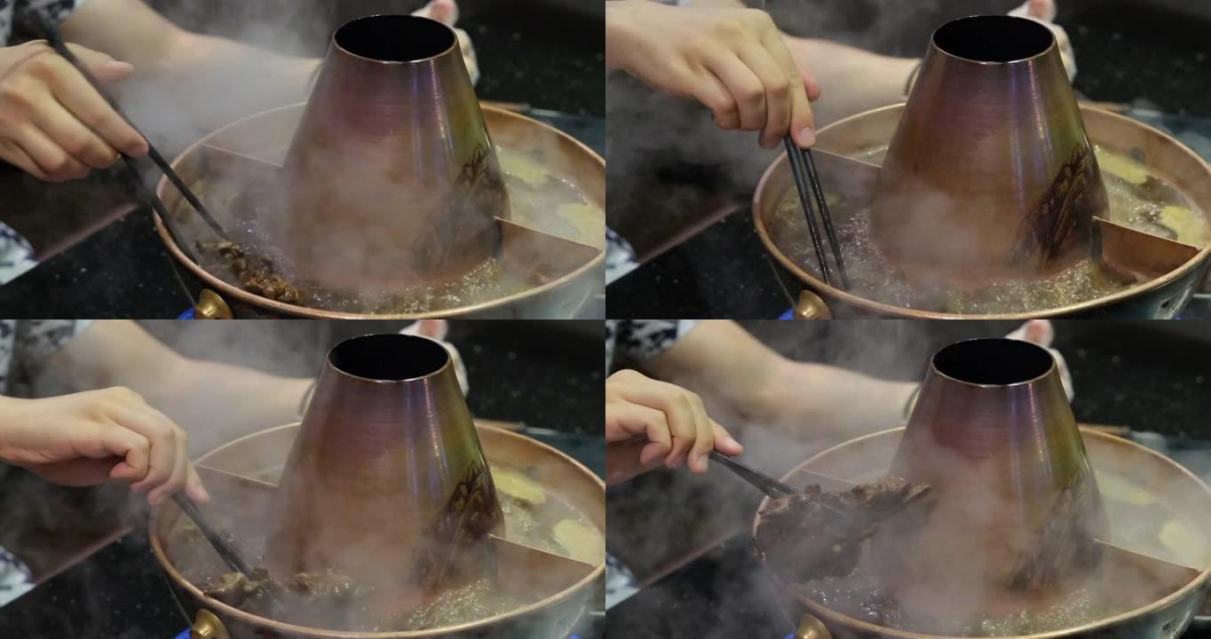 人们吃中国传统羊肉火锅。慢动作