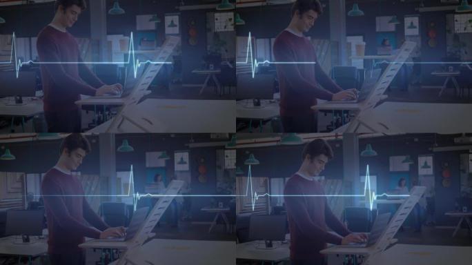 发光蓝色心率监测器的动画，在办公室站立的桌子上使用笔记本电脑