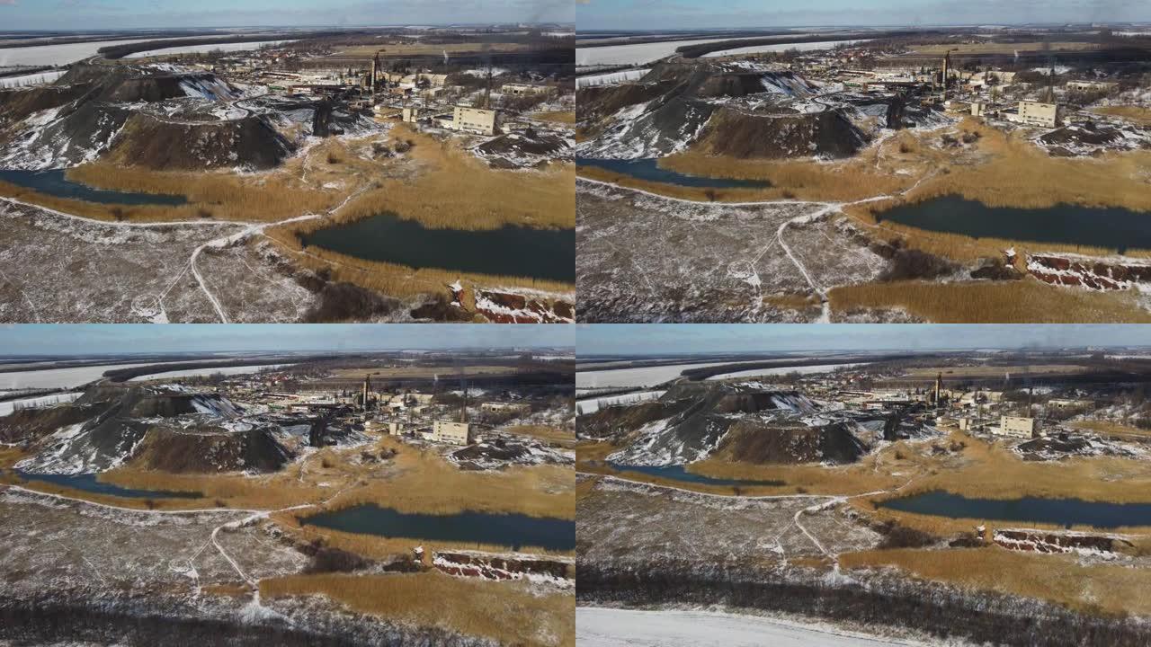 化石提取工厂的航拍。无人机飞越工业采矿坑。背景下美丽的冬季全景景观。环境污染问题。制造的概念。