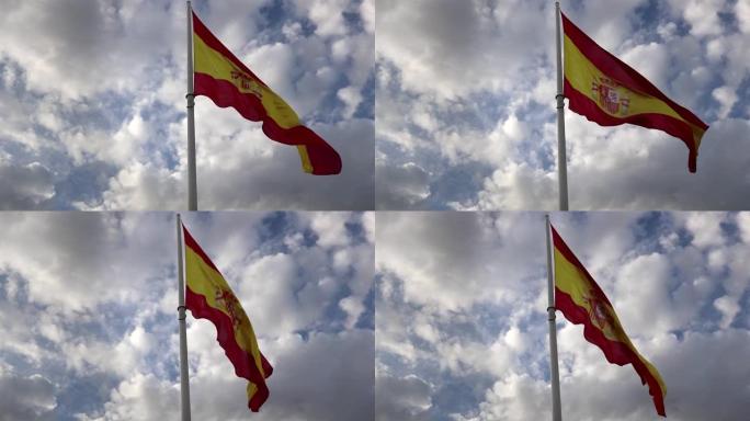大西班牙国旗在天空中挥舞着蓝色的背景，云彩-放置在西班牙马德里的科隆广场上