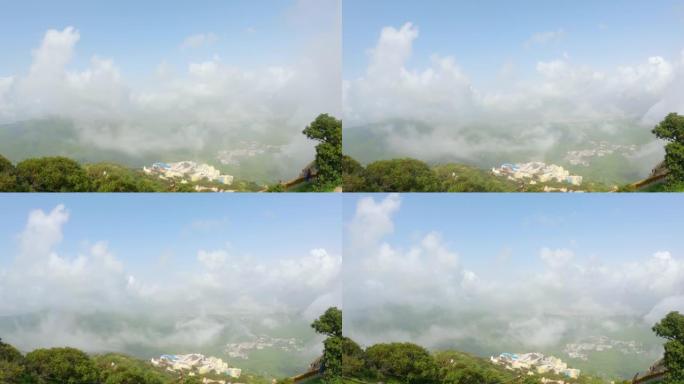 4 k。从吉纳尔山上看，时间流逝的云覆盖了Neminath Jain寺庙和Junagadh市。城市上