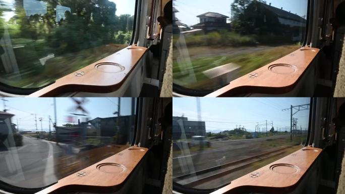 在熊本市行驶的日本火车窗户上的4k镜头