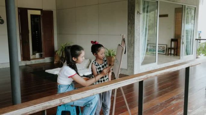 泰国年轻女子假日教妹妹画画 -- 股票视频