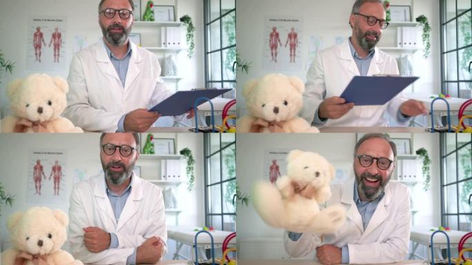 开朗的成熟男性儿科医生在办公室的视频通话中向泰迪熊打招呼