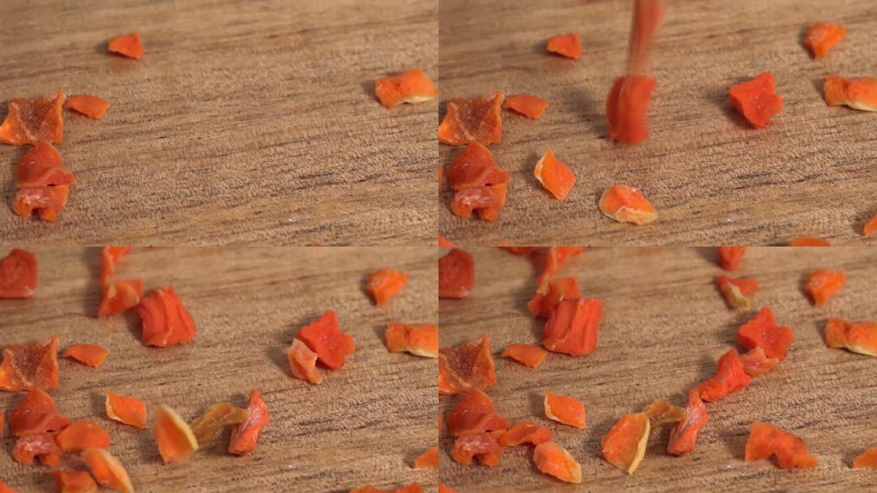 干胡萝卜落在木质表面上，特写，宏观。慢动作