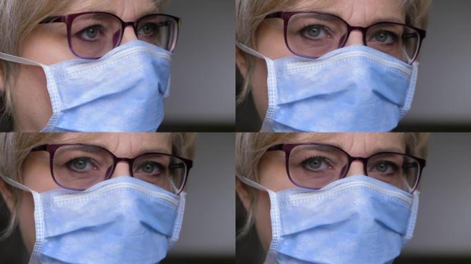 电晕病毒流行病-戴着外科口罩看着相机的迷人女人