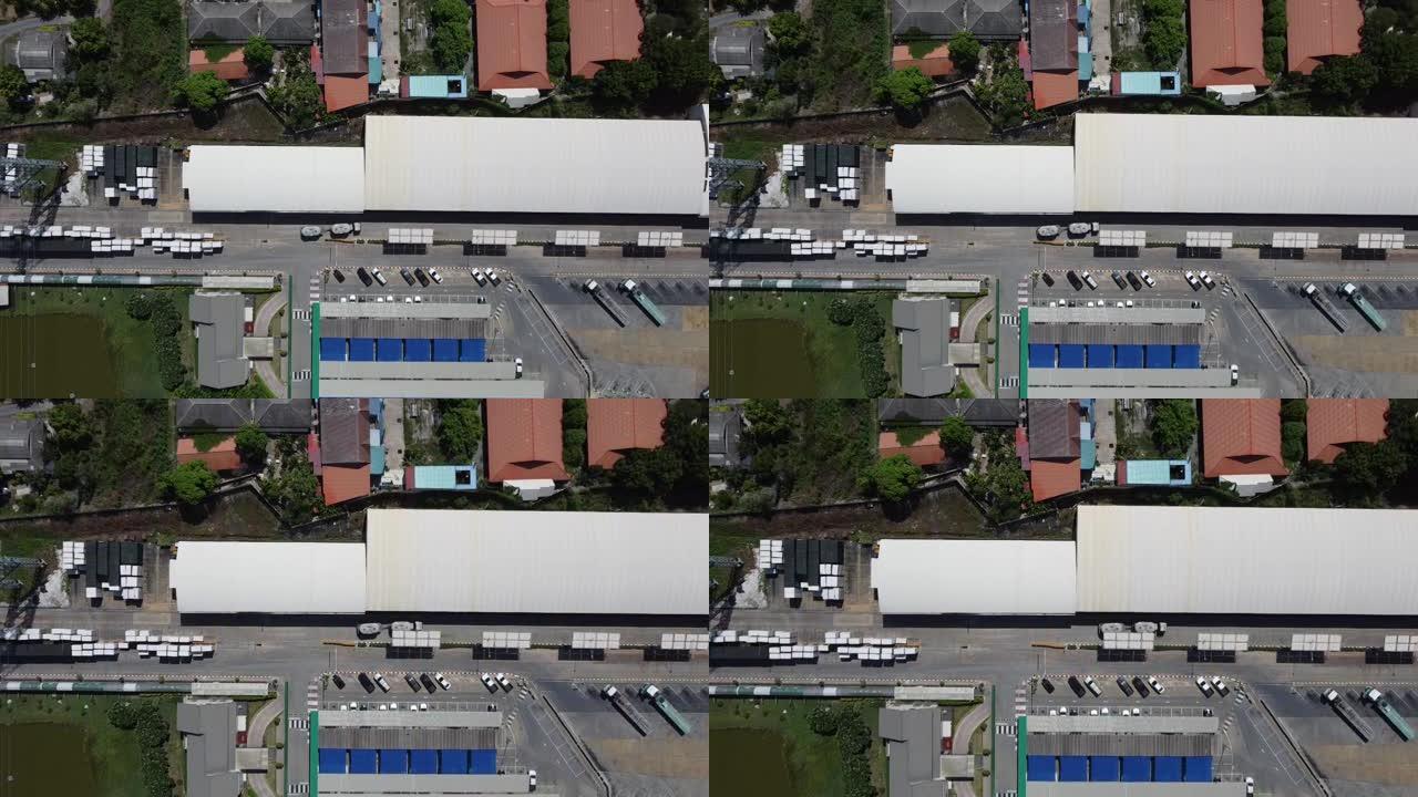 工厂屋顶上的4k从鸟瞰仓库中跟踪汽车和卡车