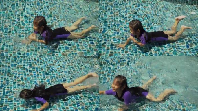 穿着泳衣的亚洲女孩在户外游泳池玩耍或游泳