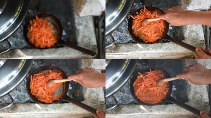 用胡萝卜在明火在农村厨房中制作食物的传统方法