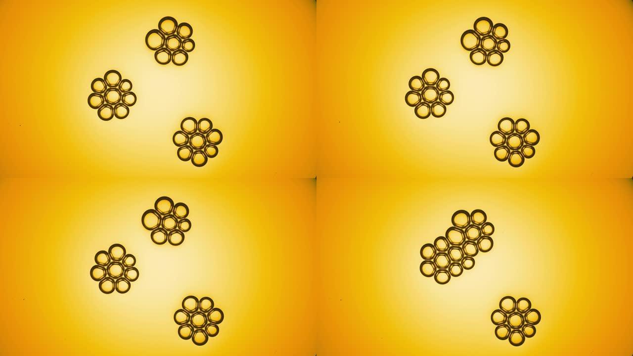 黄色气泡簇慢慢靠近并相互结合