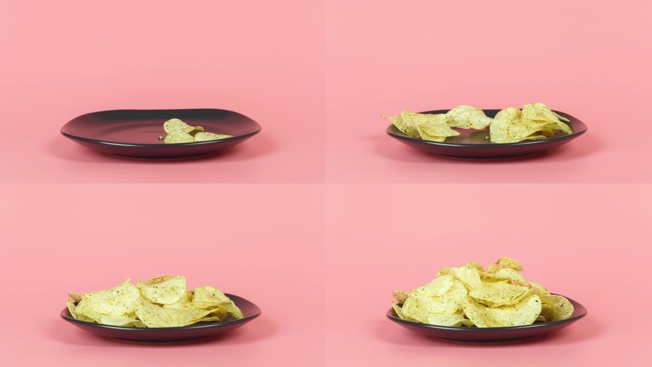 薯片在黑色碟片粉红色背景下增加。吃动画。