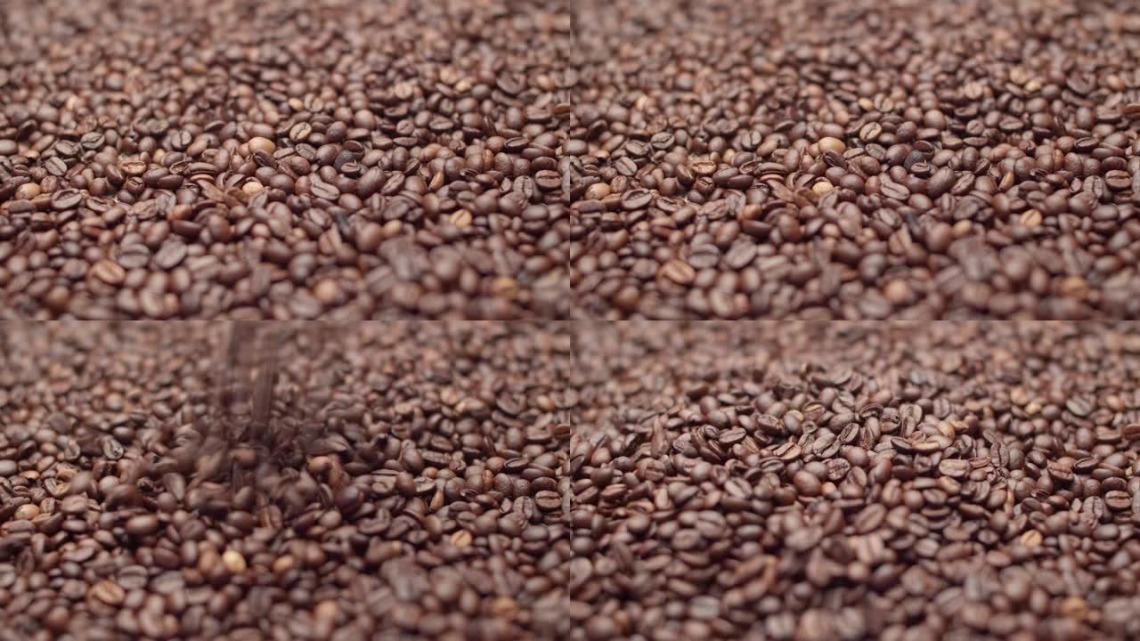 大量咖啡豆落在填充背景的大量咖啡豆上。概念语气和活力