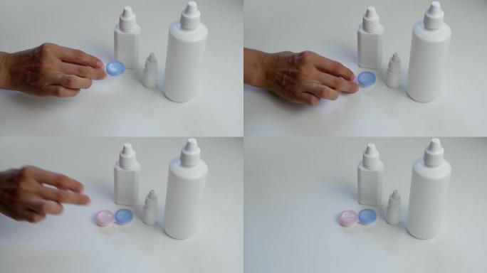特写镜头将镜头存储溶液从白色瓶子倒入塑料容器中。日常镜片护理。