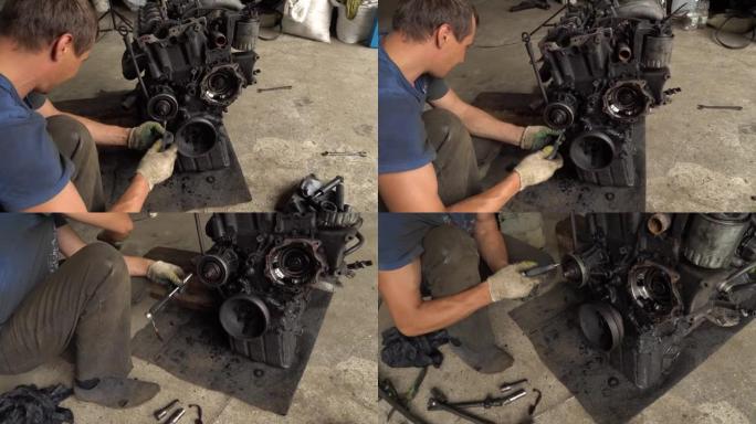 汽车修理工检查内燃机。发动机被油弄脏了
