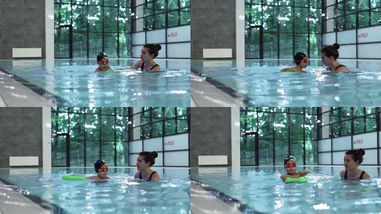 游泳课水上教练教练教小孩在游泳池游泳潜水浮子