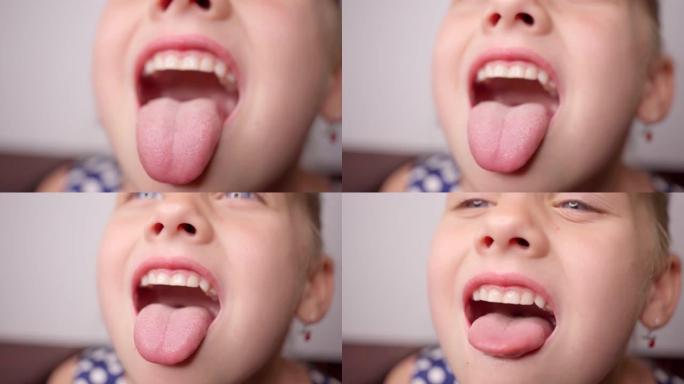 女孩张开嘴，拔出长舌头。孩子露出牙齿