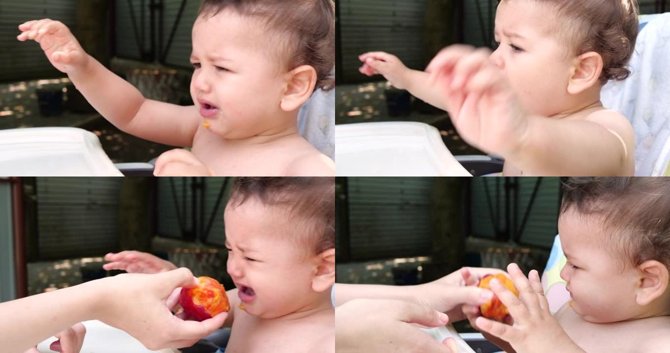 一个小孩坐在婴儿喂奶的椅子上，夏天吃桃子。童年的概念。特写镜头